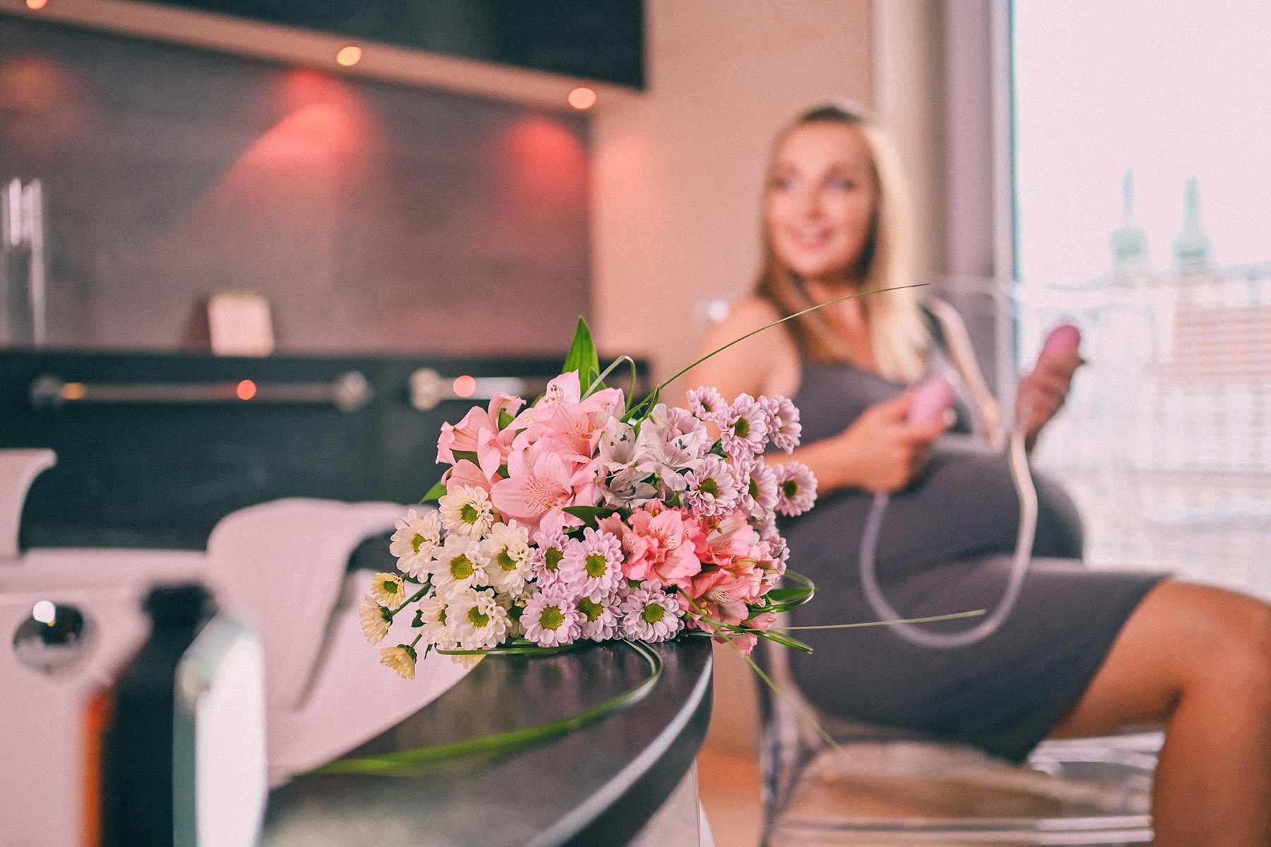 Pregnant Woman with Flowers Sitting Holding Aniball